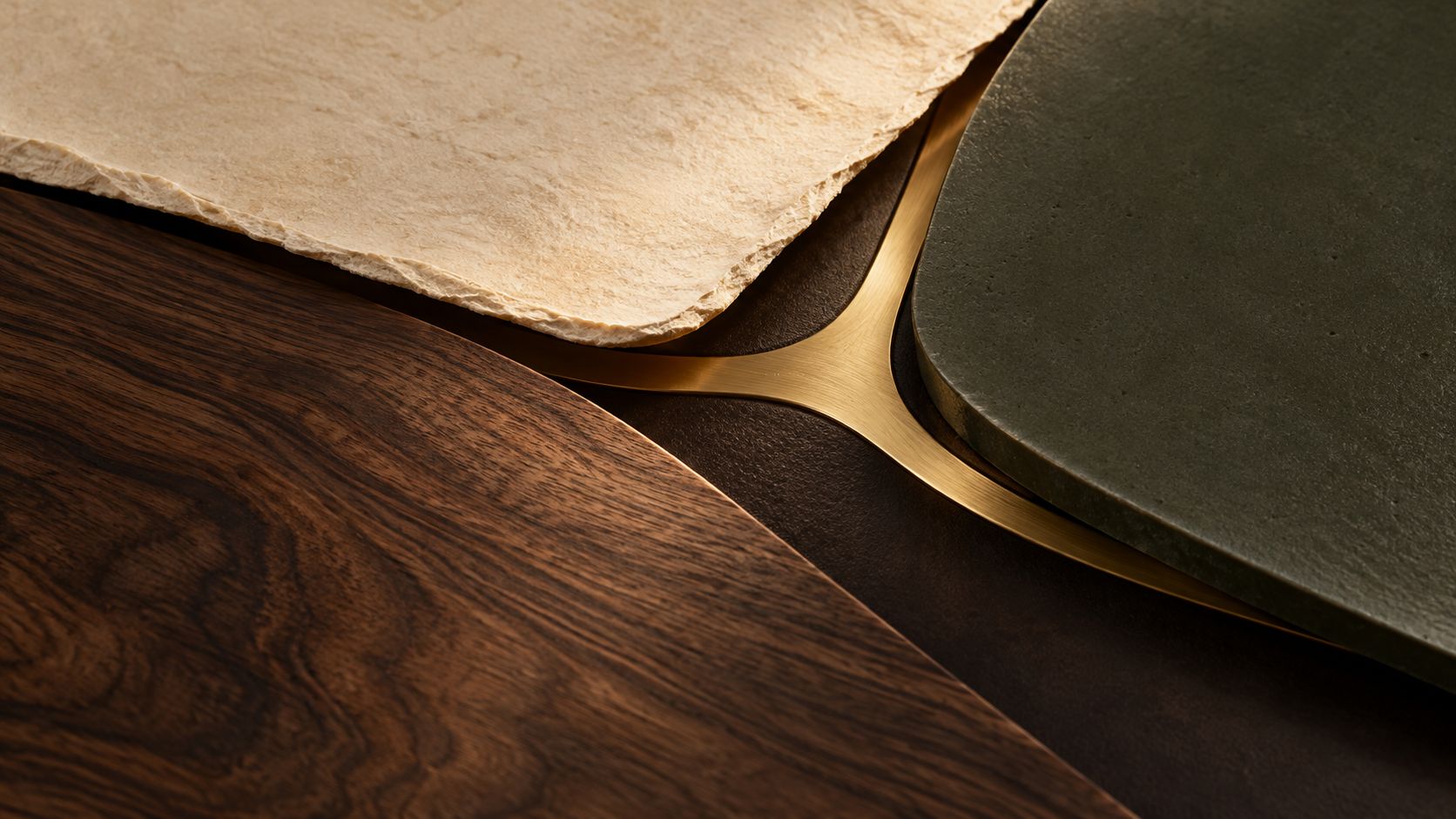 Conceptual close-up of overlapping ivory, walnut and olive layers revealing a connected brass seam.